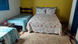 Ένα ή περισσότερα κρεβάτια σε δωμάτιο στο Casa de Praia Ilhéus