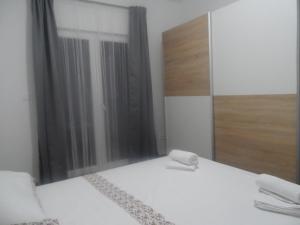 Postel nebo postele na pokoji v ubytování Apartmani Dropulić