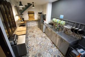 
a kitchen with a stove, sink, and cabinets at The Lights Hostel in Málaga
