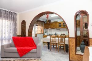 a living room with an archway and a dining room at Mar Rosa in Aguçadoura