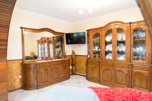 a living room with wooden cabinets and a mirror at Mar Rosa in Aguçadoura