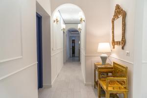 a hallway with a table and a mirror and a chair at B&B La Residenza di Michelangelo in Florence