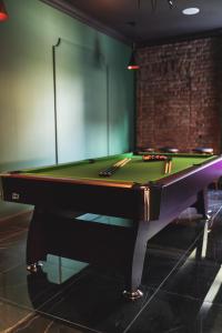 a pool table sitting in a room with avertisementvertisementosateosateosateosateosate at Holiday House Apartament 95m2 Deptak Bogusława in Szczecin