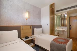 เตียงในห้องที่ Holiday Inn Express Bengaluru Whitefield ITPL, an IHG Hotel