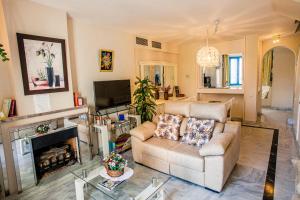 uma sala de estar com um sofá e uma lareira em Duplex apartment on the beach 71 em Marbella