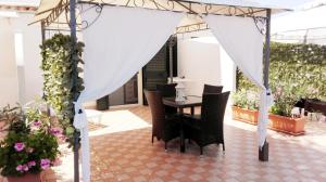 a patio with a table and chairs under a tent at Residence Maresol in Vieste