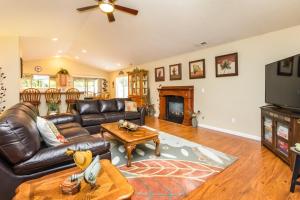 a living room with a leather couch and a television at Charming Wine Country Retreat! 4 Bedroom 2 Bath in Walla Walla