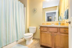 a bathroom with a toilet and a sink and a mirror at Charming Wine Country Retreat! 4 Bedroom 2 Bath in Walla Walla +15 photos