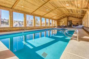 an indoor swimming pool with a wooden ceiling at Timberbrook #215A in Brian Head