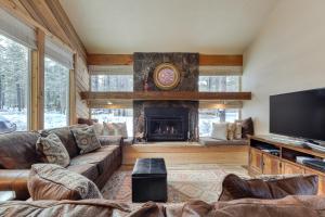 a living room with a couch and a fireplace at 2 Conifer in Sunriver