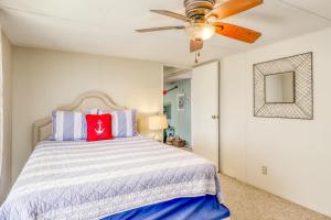 a bedroom with a bed and a ceiling fan at Sandy Toes in Mexico Beach