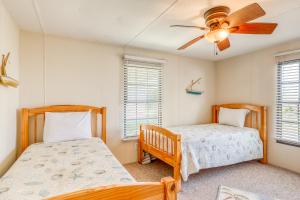 a bedroom with two beds and a ceiling fan at Sandy Toes in Mexico Beach