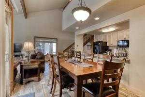 a kitchen and dining room with a wooden table and chairs at 2 Conifer in Sunriver