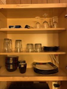 a shelf filled with pots and pans and dishes at The North Face Lodge in Lake City