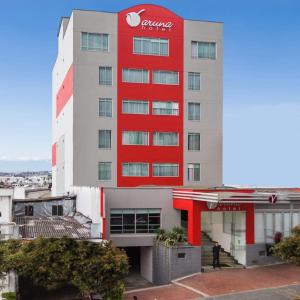 a hotel with a red stripe on the front of it at Hotel Varuna in Manizales
