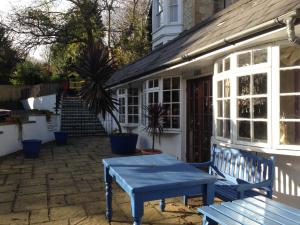 a wooden bench sitting in front of a house at Holliers Hotel in Shanklin