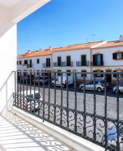 a view of a building from a balcony at Casa Cor-de-Rosa in Vila Nova de Milfontes