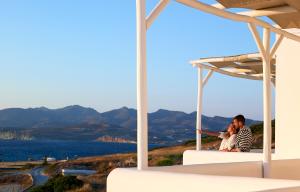 a man and a woman sitting on top of a house at Villa Gallis in Pollonia