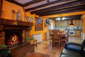 a living room with a fireplace and a dining room at Casa Navarlaz S N in Valcarlos