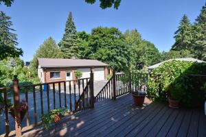 a deck with a fence and some plants at 10th Avenue Guest House & Suites in Hanover