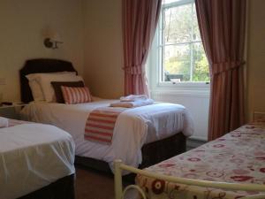 a room with two beds and a window at Lubnaig Guest House in Callander