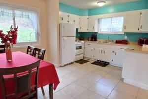 a kitchen with a table with a red table cloth at LAKE GEORGE FAMILY VACATION HOME in Lake George