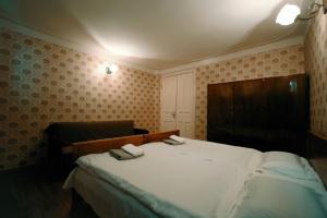 Postel nebo postele na pokoji v ubytování Guest House Old Kutaisi