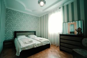 Postel nebo postele na pokoji v ubytování Apartment OLD KUTAISI
