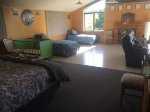 a hotel room with a bed and a living room at Waiotahe Dairy Farm Hideout in Waiotahi