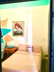 
a bed in a room with a blue blanket at MEDUSA'S HOSTEL in Aguadilla
