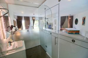 a bathroom with a glass shower and a sink at Z Exclusive Hotel and Villas in Oludeniz