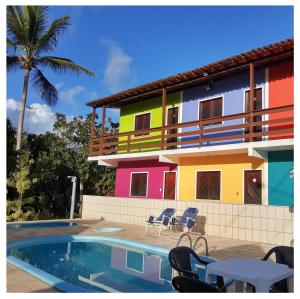 a building with a pool in front of a house at Pousada Villa Graciela in Ilhéus