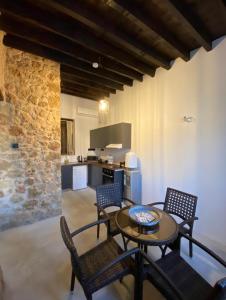 een woonkamer met een tafel en stoelen en een keuken bij Jasmine Lodge in Famagusta