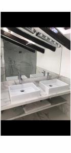 a bathroom with two sinks and a mirror at In Un Borgo Nel Centro Storico in Bologna