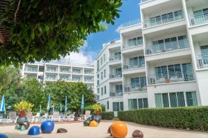 an apartment building with colorful balls in front of it at Cera Resort @ Cha-am in Cha Am