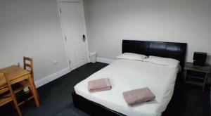 a bedroom with a large bed with two pillows on it at Just Like Home in Bristol +3 photos