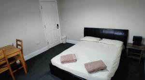 a bedroom with a large bed with two pillows on it at Just Like Home in Bristol