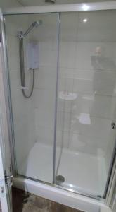 a shower with a glass door in a bathroom at Just Like Home in Bristol