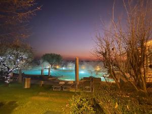 a view of a swimming pool at night at Catullo Apartments Sirmione in Sirmione