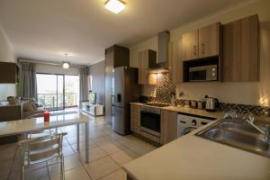 A kitchen or kitchenette at Zwelakho Furnished Apartments The Cube
