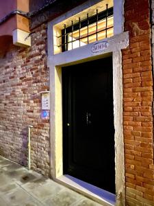 a black door on the side of a brick building at SANTA CATERINA in Venice