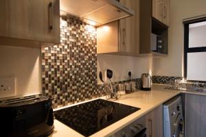 A kitchen or kitchenette at Zwelakho Furnished Apartments The Cube