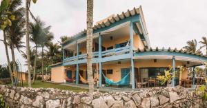 a house with a slide in front of it at Pousada Sobre as Pedras in Itanhaém