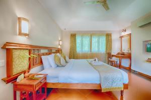 Postel nebo postele na pokoji v ubytování Greenwoods Resort, Thekkady