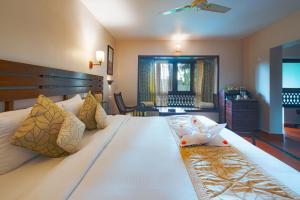 Postel nebo postele na pokoji v ubytování Greenwoods Resort, Thekkady