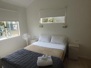 A bed or beds in a room at Grassy Head Holiday Park