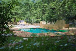 un patio trasero con piscina, una silla y un banco en Duub Hostel, en Las Trancas