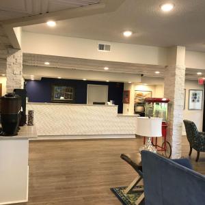 a lobby with a bar in the middle of a room at SureStay Plus Hotel by Best Western Southern Pines Pinehurst in Southern Pines