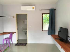 Habitación con aseo, TV y ventana. en Pak Dee Resort, en Nakhon Ratchasima