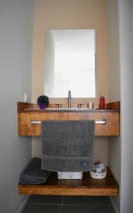 a bathroom with a sink and a mirror at Florencia Departamentos in Tandil